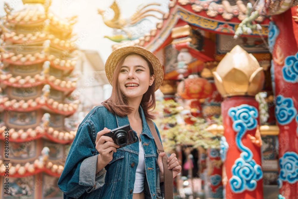 Smiling traveler backpack woman shooting camera. Walking street.