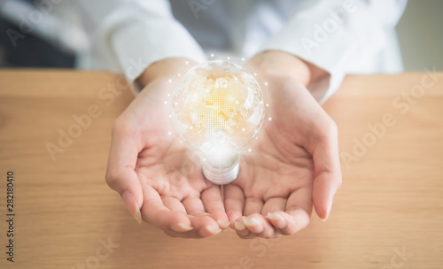 Businesswoman holding light bulb with innovative and creativity are keys to success. Concept knowledge leads to ideas and inspiration.