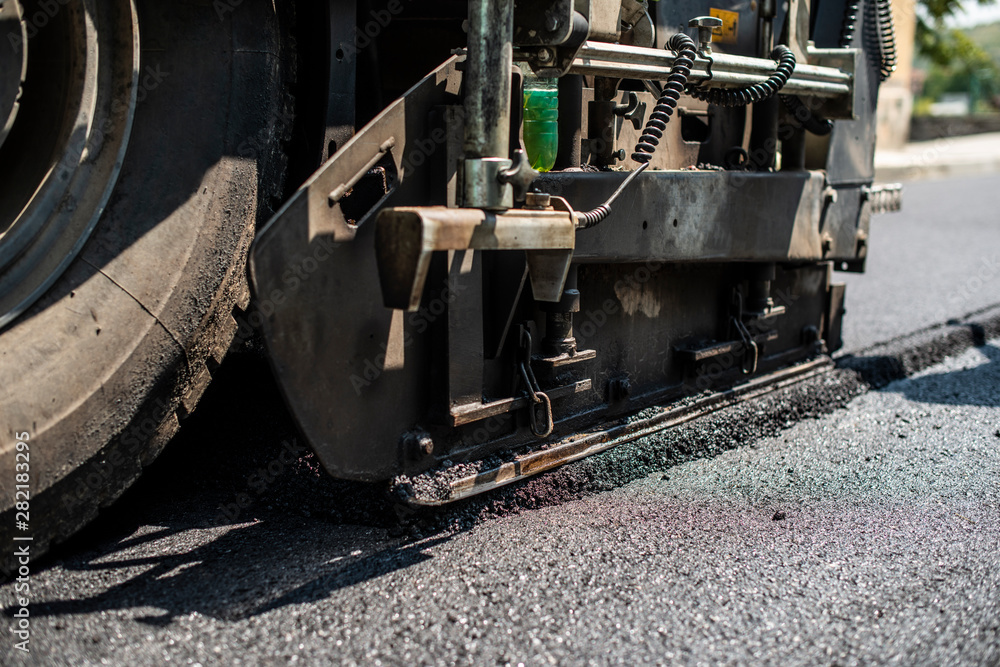 Asphalting machine on the road. Asphalting machine on the road.