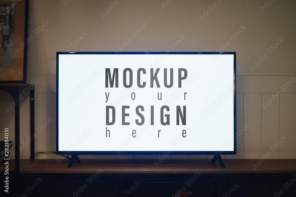 TV with blank screen and shelf cabinet at night in contemporaly living room, Mockup blank screen LED TV for your advertisement artwork. Tv mockup in living room at night.