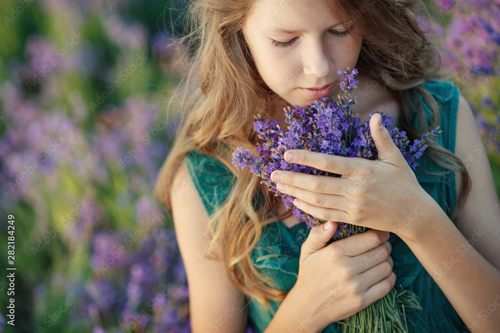 Fototapeta premium Teenager girl in a field with flowers. 