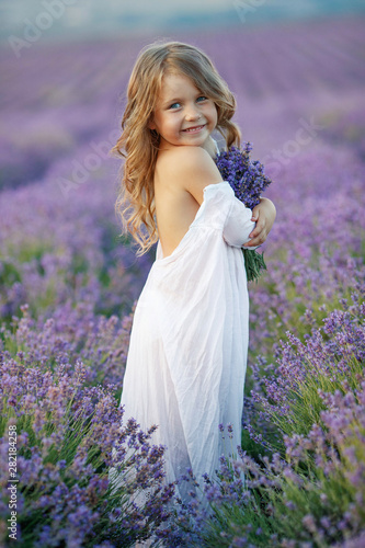 Little girl in a field with flowers. 