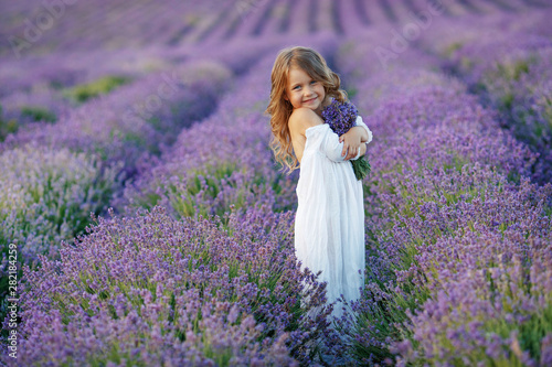 Little girl in a field with flowers. 