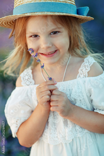 Little girl in a field with flowers. 