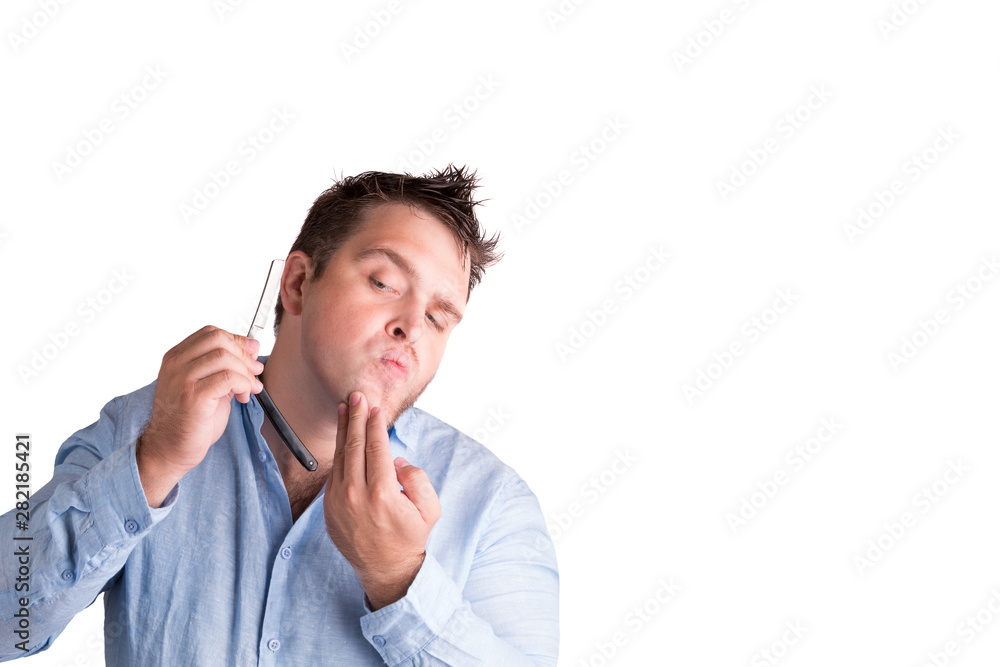 Shaving with a razor close-up on a white background. A young man with a razor in his hand. A man shaves with a razor. 