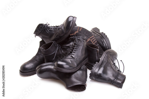 Men's shoes are stacked in a pile. Men leather shoes close-up. A pile of men's shoes isolate on a white background.