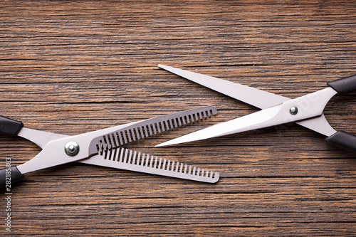 Barber scissor blades. Barber scissors on a wooden background close-up.