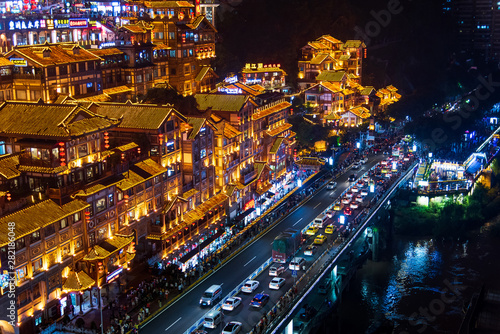 Chongqing, China - July 23, 2019: Hongya cave in Chongqing with modern skyline and skyscrapers in the background