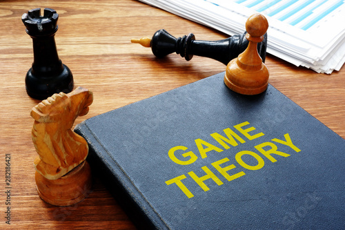 Game theory book and chess with documents. photo