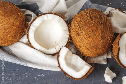Pile of broken coconuts on ripped grey background