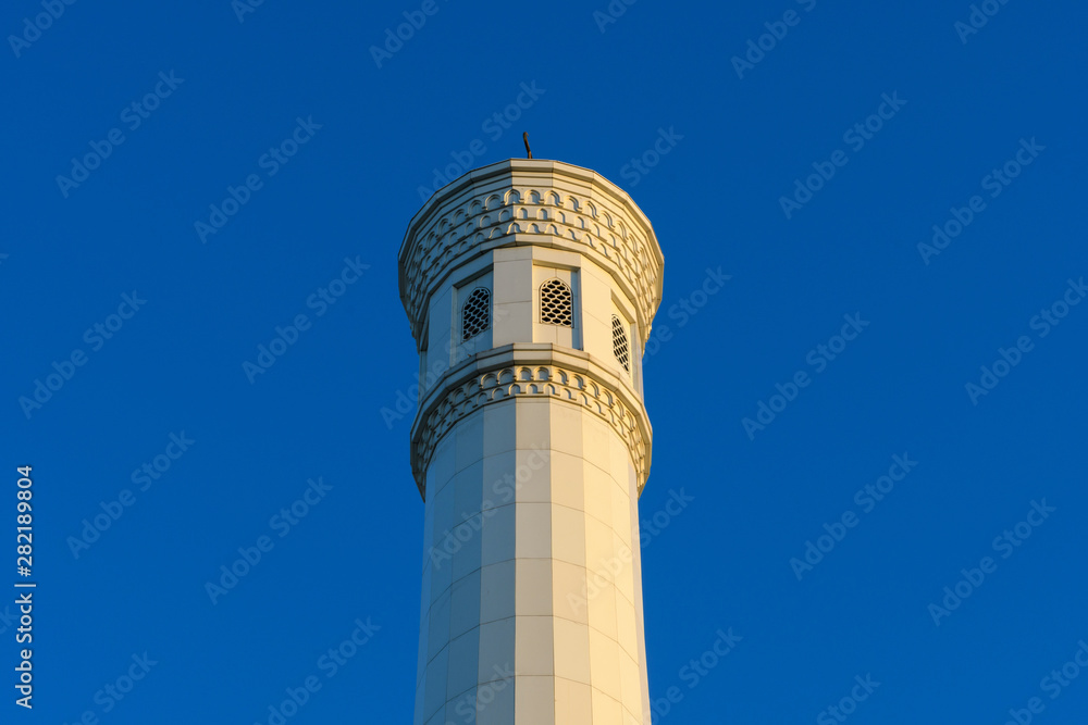Minaret of the White Minor Mosque against the blue sky