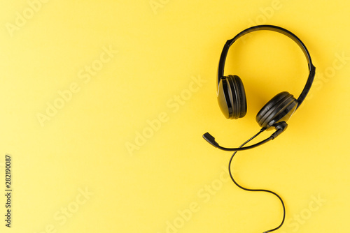 Customer service headset on yellow background. Call center concept