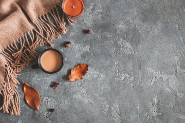 Autumn composition. Cup of coffee, plaid, autumn leaves on black background. Flat lay, top view, copy space