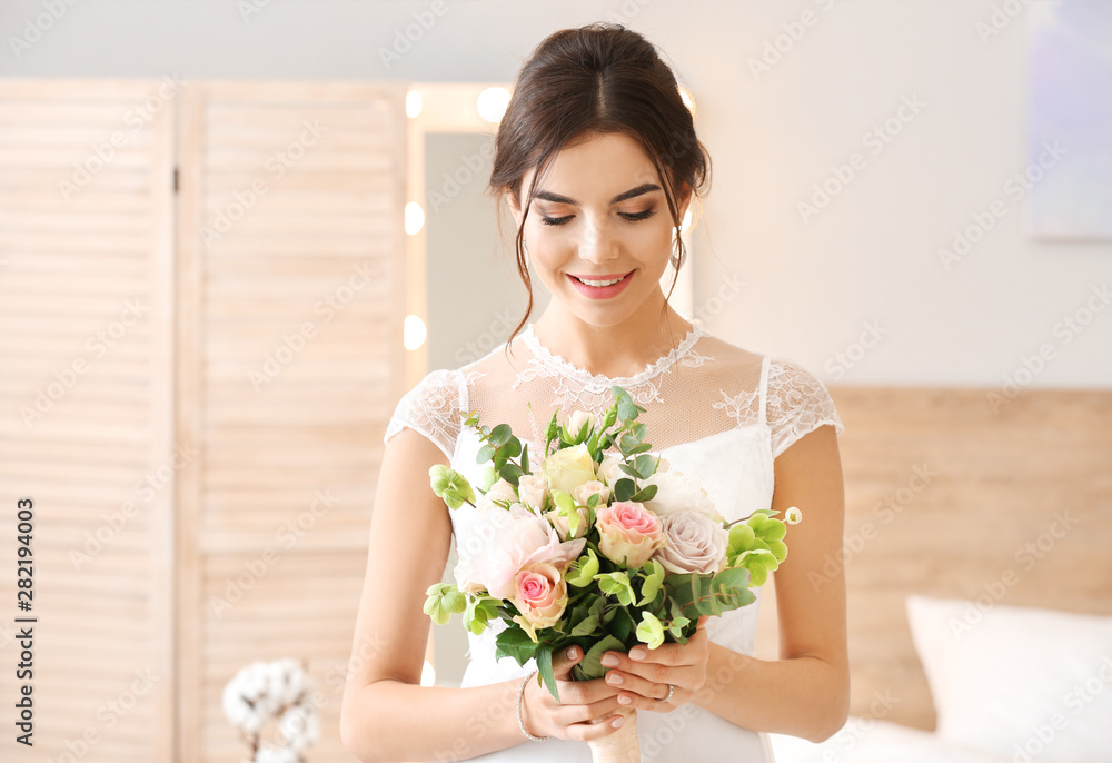 Beautiful young bride with bouquet of flowers at home Beautiful young bride with bouquet of flowers at home