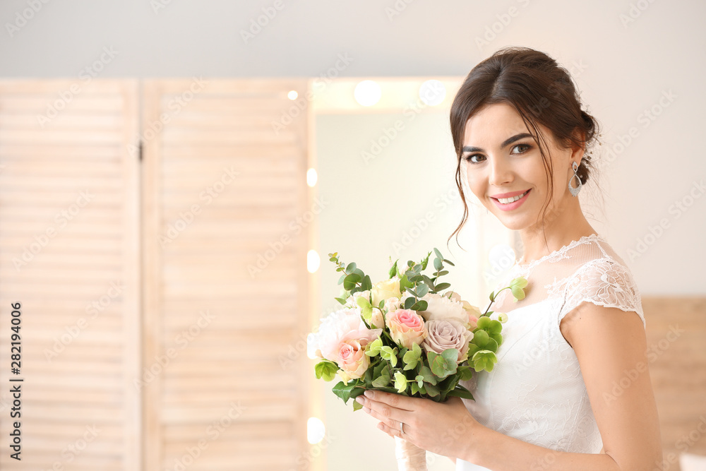 Beautiful young bride with bouquet of flowers at home Beautiful young bride with bouquet of flowers at home