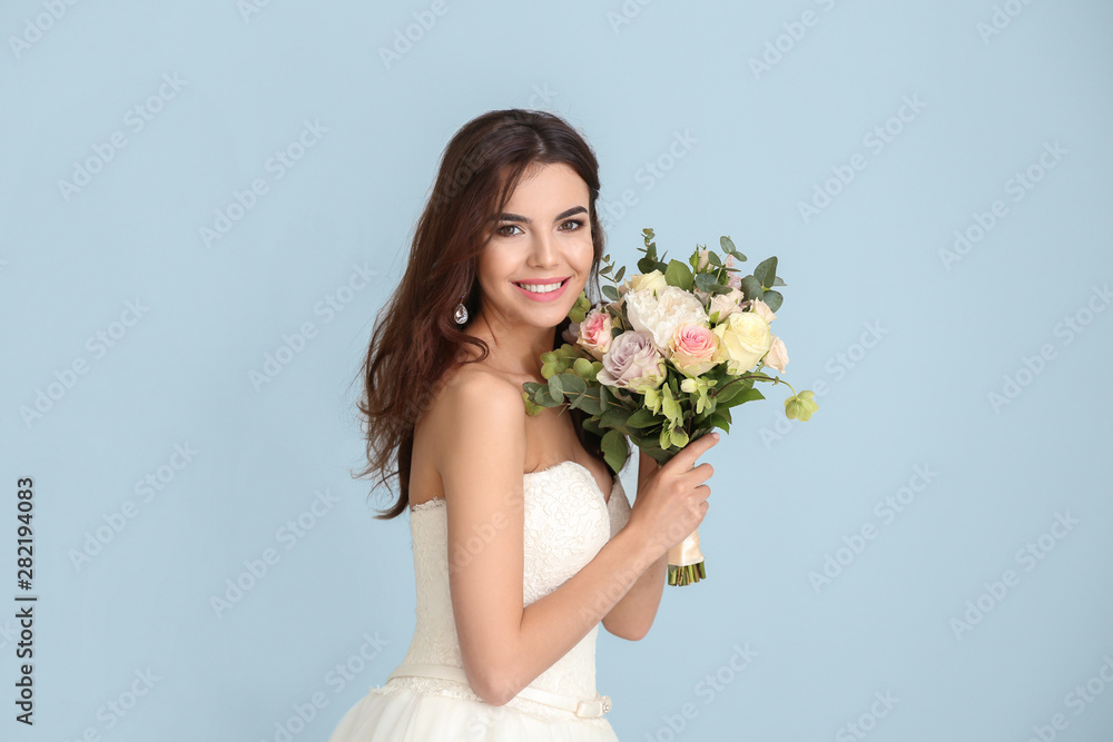 Beautiful young bride with bouquet of flowers on color background Beautiful young bride with bouquet of flowers on color background