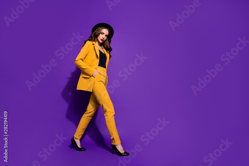Profile side full length body size view of nice-looking gorgeous attractive lovely content wavy-haired lady motion strolling podium step isolated over bright vivid shine violet lilac background