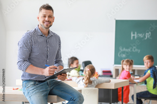 Fotografie, Obraz Portrait of male teacher in classroom