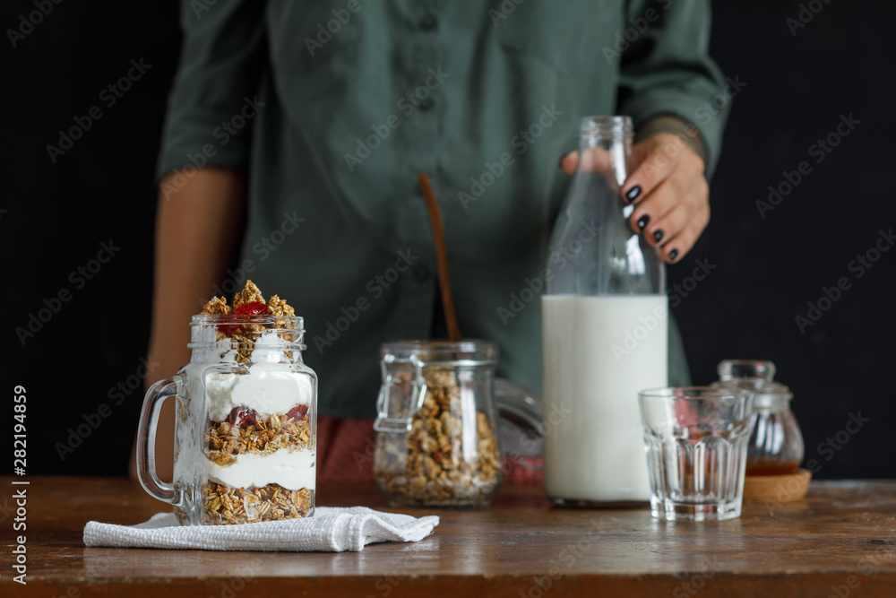 The glass of granola with dried berries and yogurt.