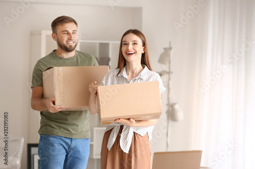 Happy young couple with moving boxes in their new house © Pixel-Shot