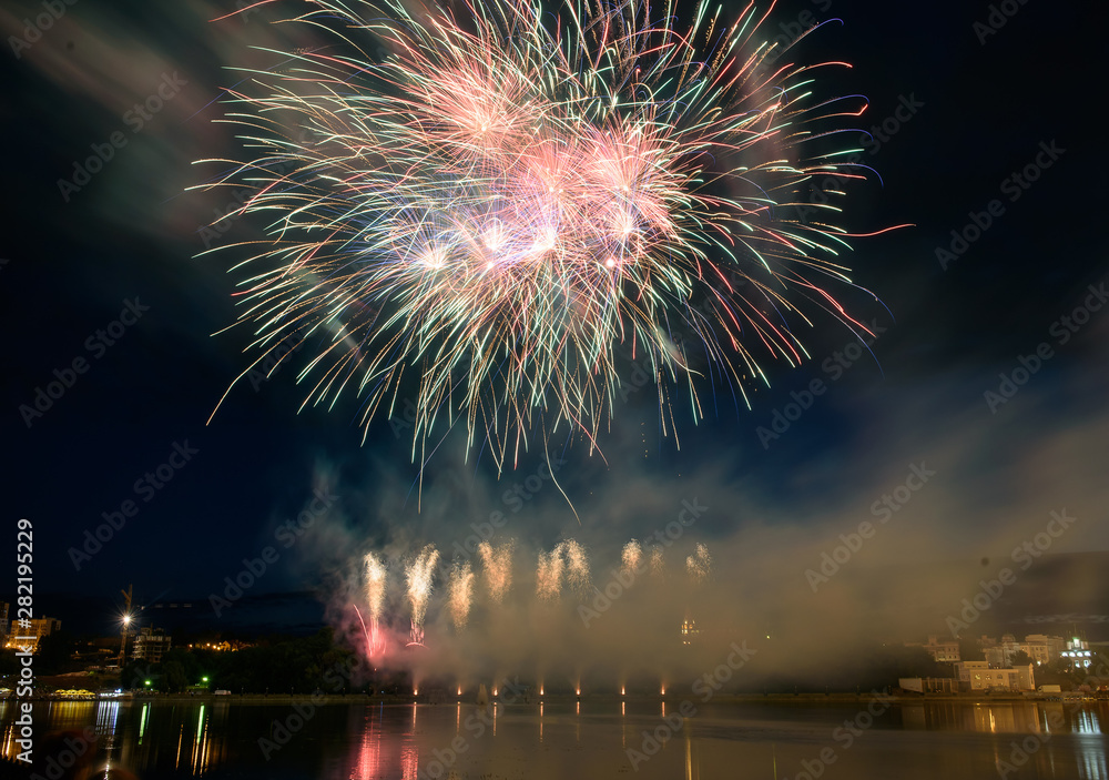 Beautiful pyrotechnic fireworks at night over the water. Celebration. Beautiful pyrotechnic fireworks at night over the water. Celebration.