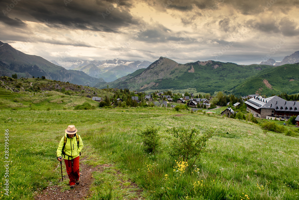 hiker woman with view of Tena Valley in The Pyrenees, Formigal, Huesca, Spain hiker woman with view of Tena Valley in The Pyrenees, Formigal, Huesca, Spain