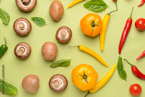 Assortment of fresh vegetables and mushrooms on color background