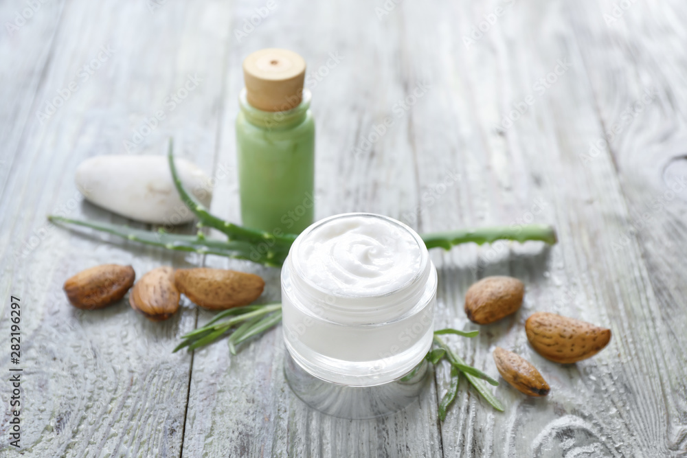Jar of natural cream on wooden background