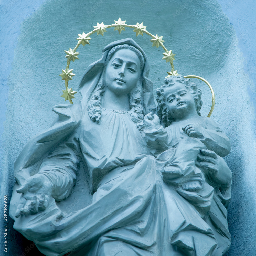 Ancient statue of the Virgin Mary with Jesus Christ. Religion, faith, love, Christianity concept.