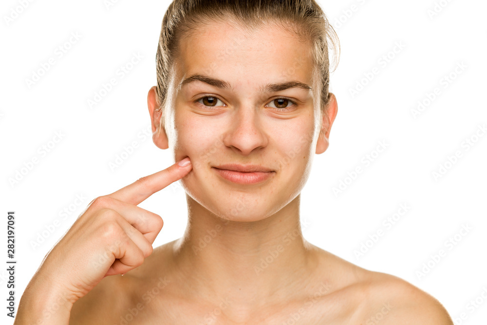 young beautiful woman touches her cheek on white background young beautiful woman touches her cheek on white background
