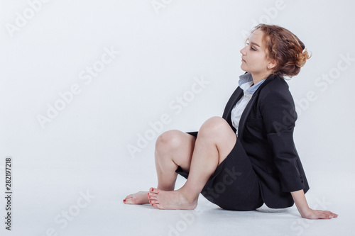 Woman in alcohol intoxication after corporate party eating berry. Pin up female style. Girl wearing unbuttoned business blouse and bra looking seductively with passion. photo