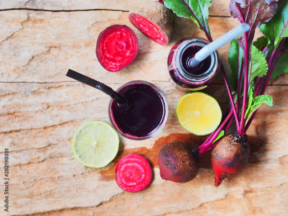 Fresh beetroot and lime juice topview on rustic wooden table with copy space for refreshing drinks concept.