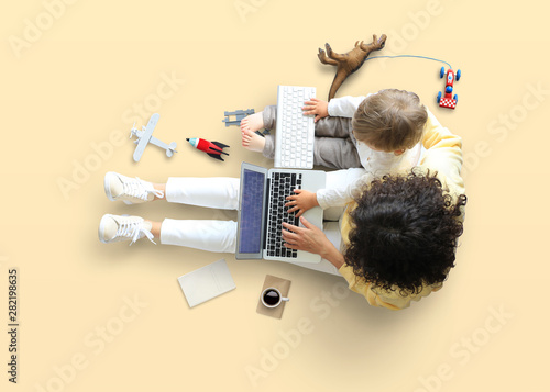 Mother teaches little son to work on the computer, education and childhood photo