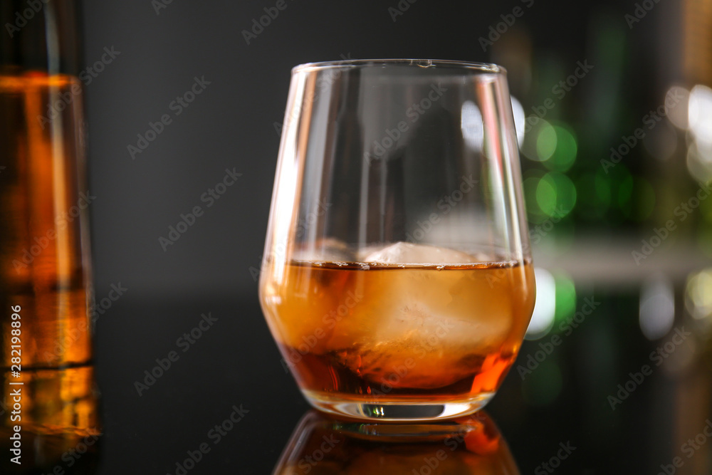 Glass of whiskey on table in bar Glass of whiskey on table in bar