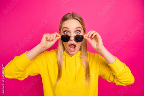 Photo of nice lady open mouth not believe awful news wear sun specs yellow hoodie pullover isolated pink background