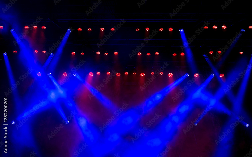 Beautiful concert light on an empty stage in the smoke. Disco and laser show.
