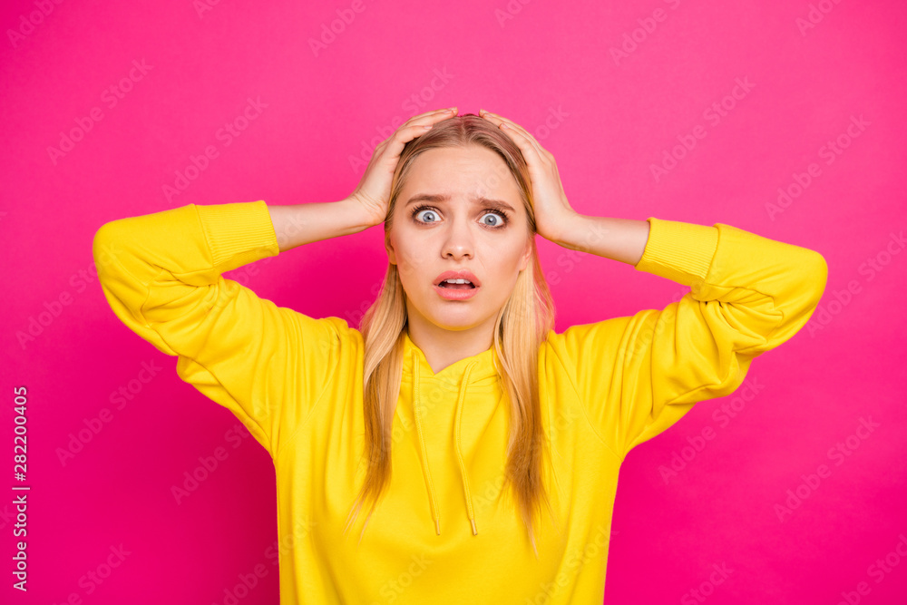Closeup photo of lady not believe awful news holding arms on head wear yellow hoodie pullover isolated pink background Closeup photo of lady not believe awful news holding arms on head wear yellow hoodie pullover isolated pink background