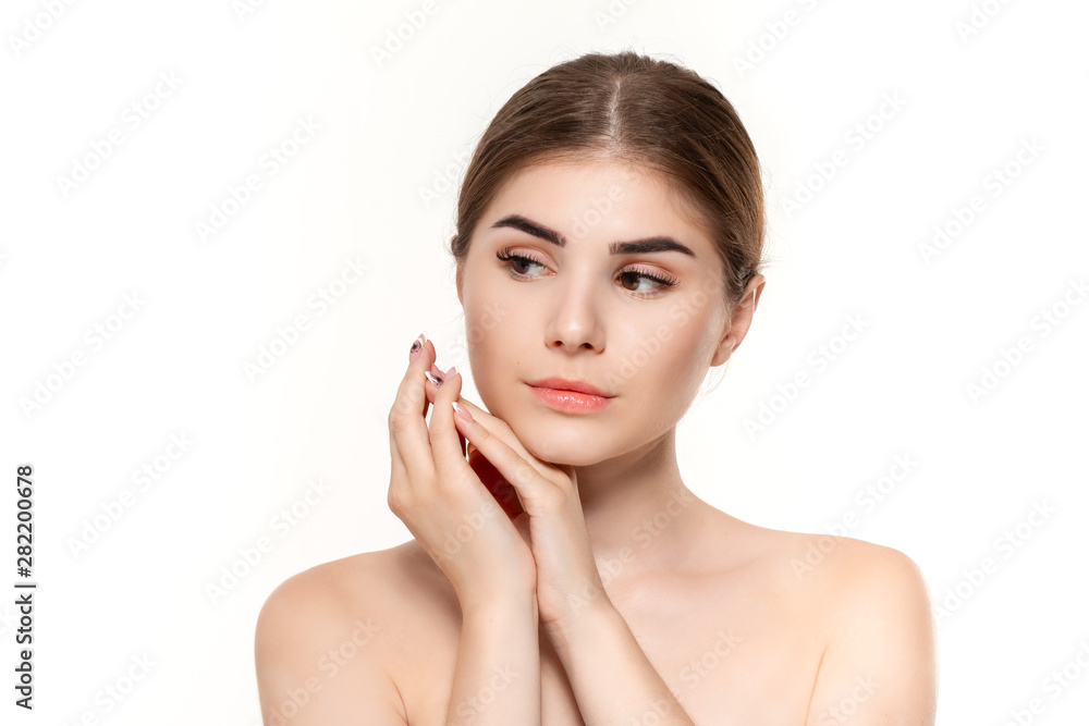 Close-up portrait of a beautiful young girl with holding hands near face isolated over white background.