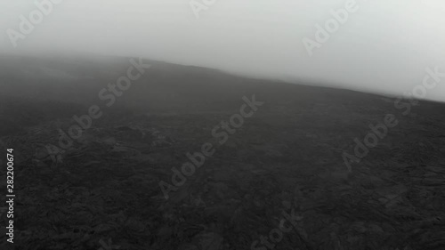 Mauna Loa aerial of lava fields at 10000 feet layered in fog. photo