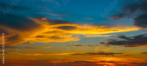 Beautiful Sunset in the sky with sky blue and orange light of the sun through the clouds in the sky, Orange and red dramatic colors - Image