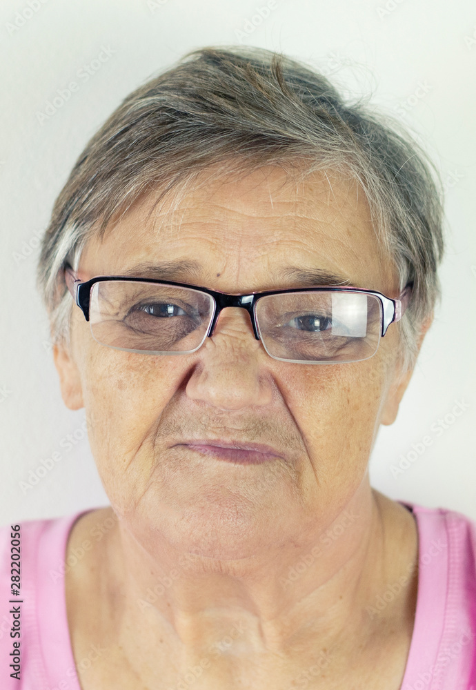 Grandma with glasses. Happy smiling pensioner wearing her new pair of glasses isolated on white background