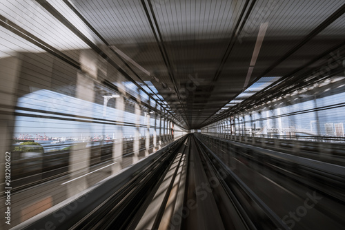 motion-blurred view from a moving train running in tunnel