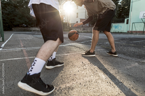 Low angle men playing basketball