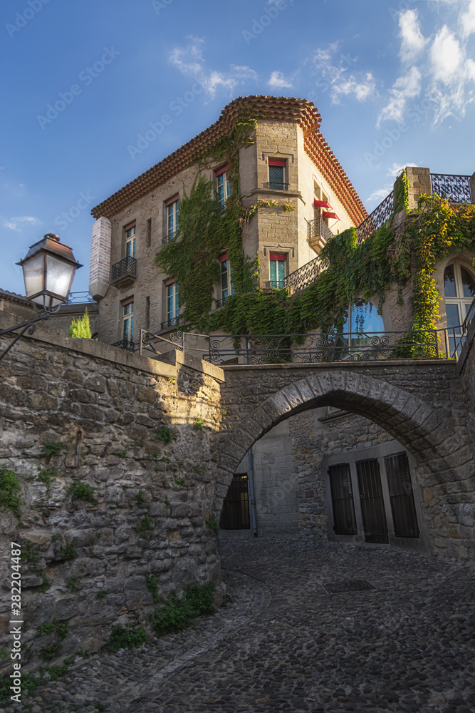 A spring scene of a beautiful alley in the fortified city of carcassone with beautiful buildings in France