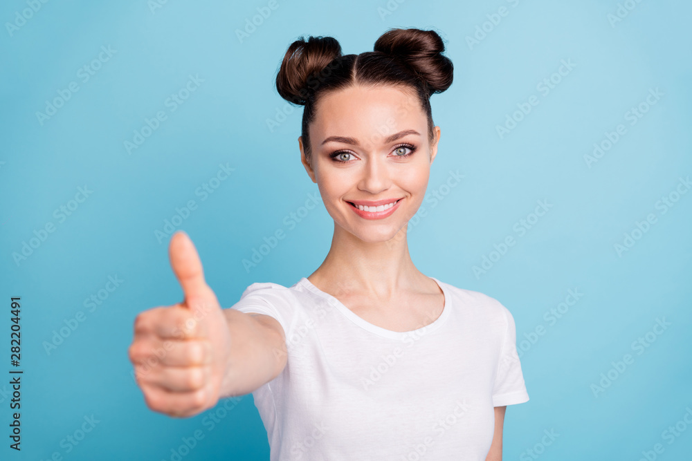 Amazing lady holding thumb up advising good quality of product wear white casual t-shirt isolated blue background Amazing lady holding thumb up advising good quality of product wear white casual t-shirt isolated blue background