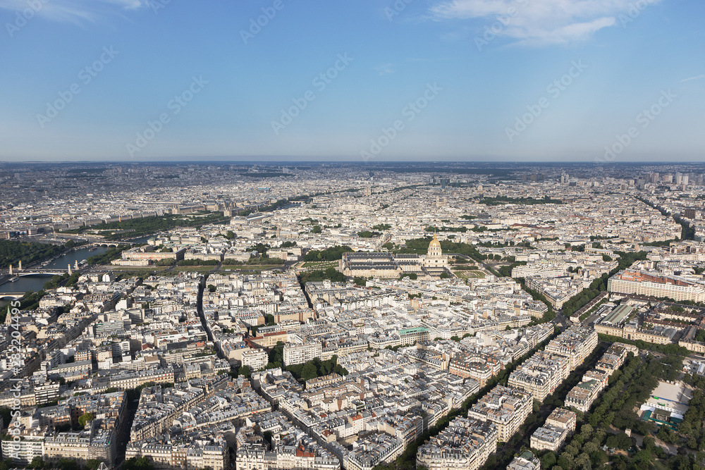 View of Paris with the Seine River in the background at a sunny day with blue sky.