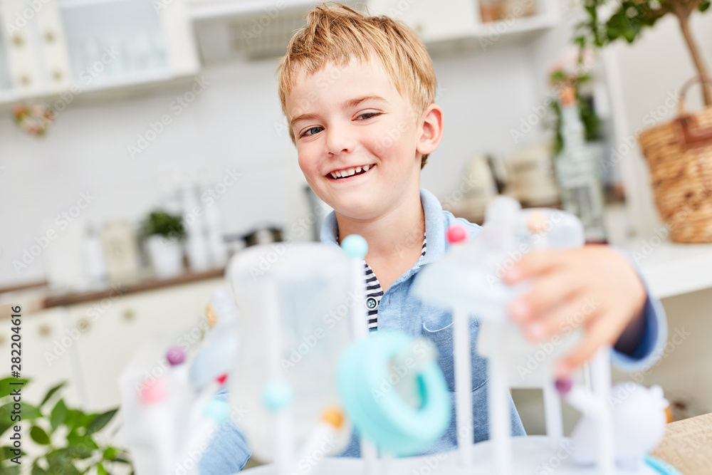 Boy helps wash baby bottles Stock Photo Adobe Stock
