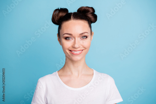 Photo of amazing lady sincerely smiling wear white casual t-shirt isolated blue background © deagreez