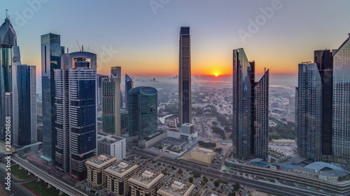 Sunrise over Dubai skyline in the morning  aerial top view to downtown city center landmarks timelapse.