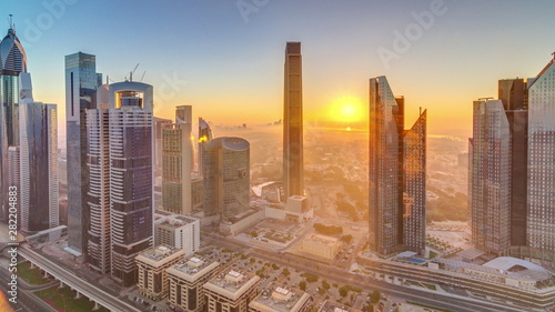 Sunrise over Dubai skyline in the morning  aerial top view to downtown city center landmarks timelapse.